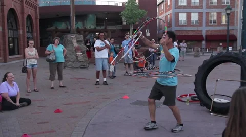 A street performer hula hoops before a crowd Stock Footage 56855654
