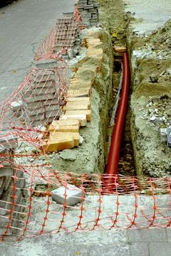Street Repair Work in Progress With Construction Materials and Safety Barrier Stock Photos