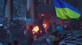 Street riot protestors with flags helmets burn open fires winter HD Footage