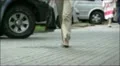 Street scene. Going feet of the woman in trousers HD Footage