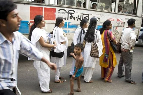 Street scene ; people standing in queue waiting for bus ; Dhaka ; Banglade... Stock Photos