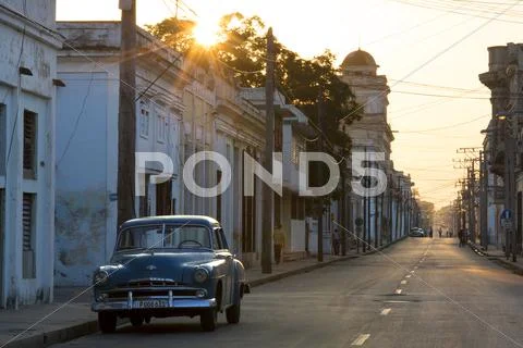 Street scene at sunrise with vintage american car, cienfuegos, unesco world h Stock Photos