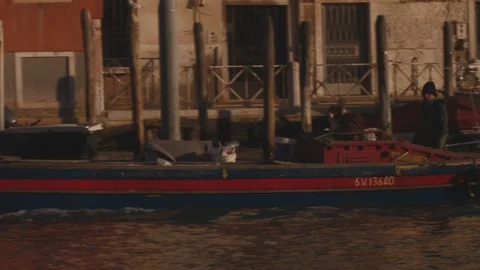 Street scene in Venice with workers and boat owners going about their business Stock Footage 128317307