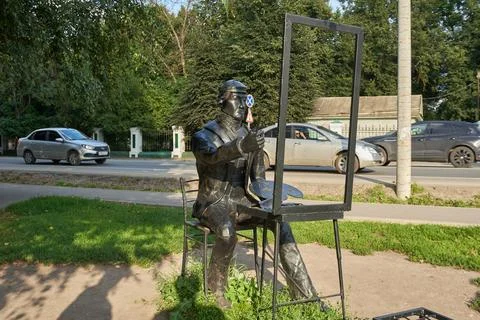 Street sculpture of painter with empty frame Stock Photos
