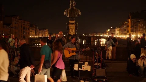 Street Singer Performs at Night at  Ponte Vecchio, Florence, With Guitar, HD Stock Footage 83361449