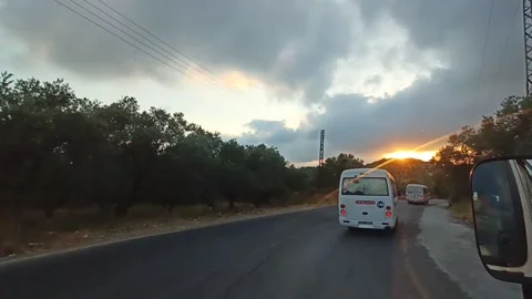 Street with sunset in the background Stock Footage 194376631