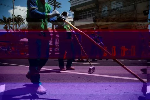 Street sweeper are seen while cleaning a street Stock Photos