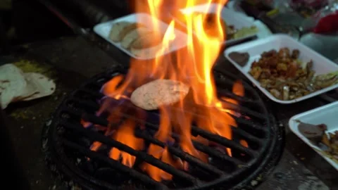 Street tacos made in fire grill. Cooking with flame in grill. Street tacos in Stock Footage 314477366