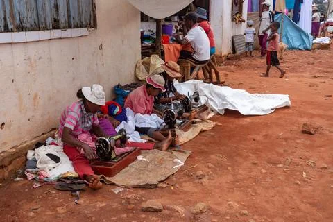 Street tailors work with their outdated manual sewing machines. Earn some m.. Stock Photos