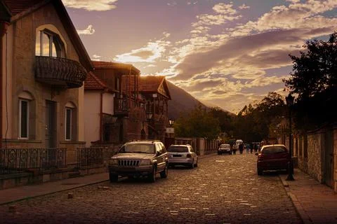 Street in the town of Mtskheta, sunset, old stone paved road. Stock Photos