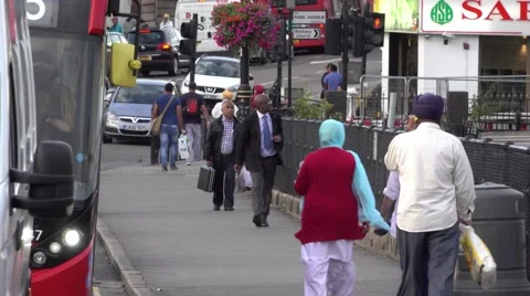 Street traffic and Indian people in Londons suburb Southall Stock Footage