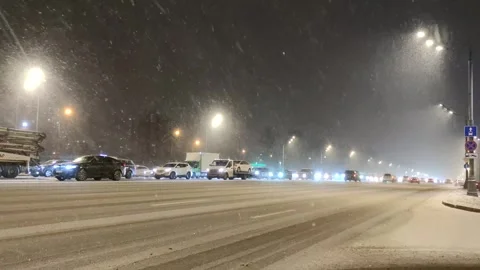 Street traffic during blizzard Stock Footage 297874440