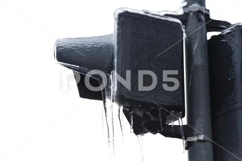 Street traffic lights covered in ice after frozen rain phenomenon Stock Photos