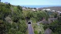 Street traffic tunnel and village in sunny green hills mountain area 4k or 4k+ Resolution