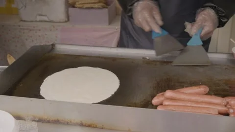 Street Vendor Cooking Flatbread and Sausages on Griddle at Beijing Food Stall Stock Footage 345904074