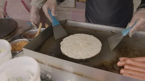 Street Vendor Cooking Flatbread and Egg on Griddle at Beijing Food Stall Stock Footage 345907789