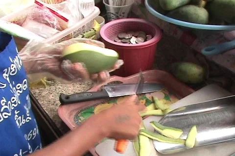 Street Vendor Cutting Up Fresh Mango Stock Footage