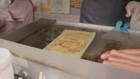 Street Vendor Grilling Flat Dough and Adding Herbs at Beijing Food Stall Stock Footage 345859031