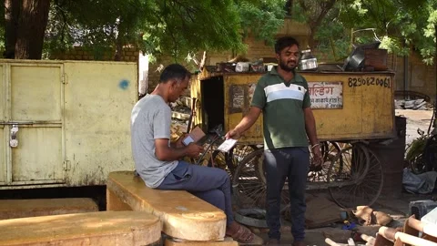 A street vendor holds a QR code board for a customer to make a digital payment Stock Footage 322717345