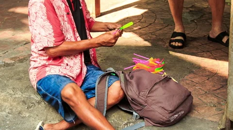 Street Vendor Launches Toy Helicopter Sitting on Pavement Stock Footage
