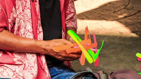 Street Vendor Launches Toy Helicopter Sitting on Pavement Stock Footage