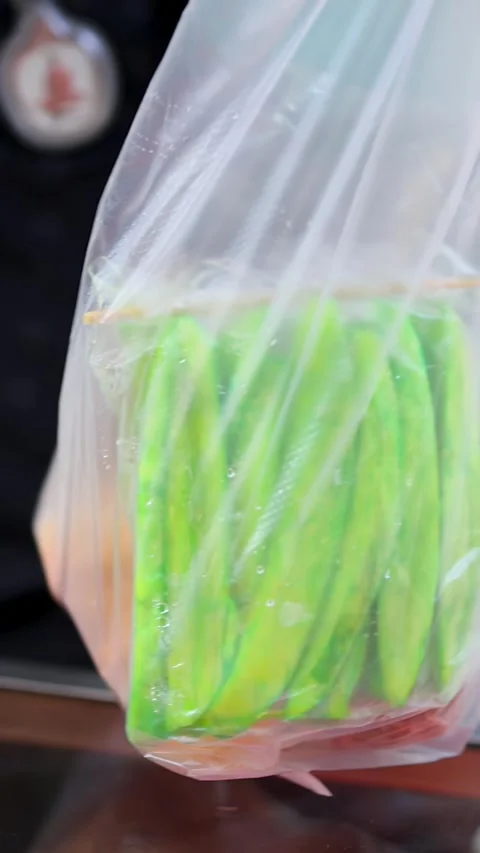 Street Vendor Packing Fresh Mango and Papaya in Bangkok Market Stock Footage 321109131