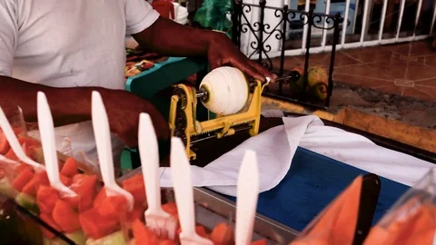 Street Vendor Peeling Orange with Machine Stock Footage