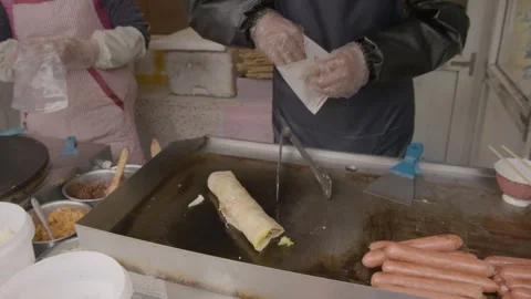 Street Vendor Preparing and Packaging Savory Snack at Beijing Food Stall Stock Footage 345922479