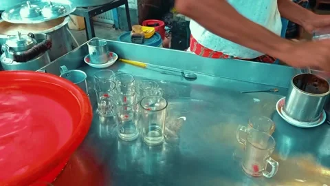 Street Vendor Preparing Aromatic Tea, Glasses, and Kettle Stock Footage 287190148
