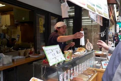 A street vendor serves a customer on Miyajama Island Stock Photos