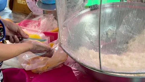 Street vendor slicing mango for mango sticky rice at local market in Thailand Stock Footage 345909732
