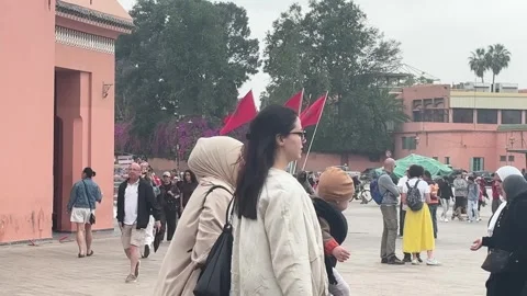 Street View of Bab Doukkala Area With Red Flags and Pedestrians in Marrakech Stock Footage 340407516