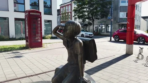 Street view of a bronze statue of schoolboy Stock Footage 201340603
