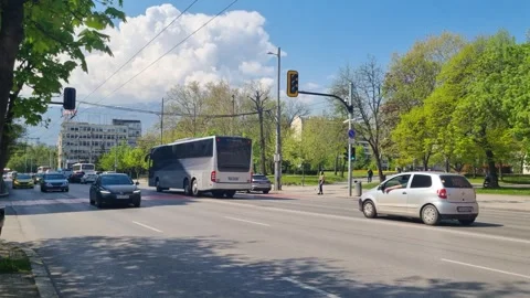 Street view in central Sofia, Bulgaria: cars and a passing tour bus move Stock Footage 327555176