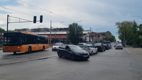 Street view in central Sofia, Bulgaria: cars and a public bus move through Stock Footage 327557254