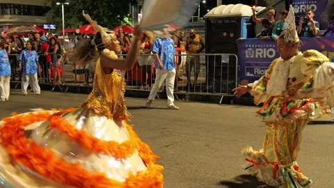 Street view at night of people dancing in a city parade during Carnaval in Rio Stock Footage 306133689