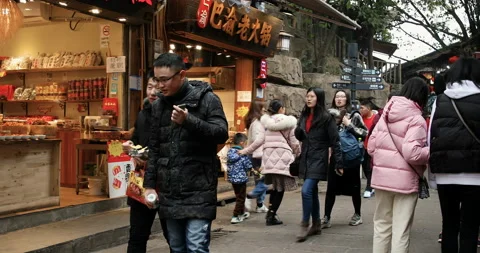 Street view of shops, stores, snack bars, tourists &amp;amp; local people at Ciqikou Stock Footage 124470936