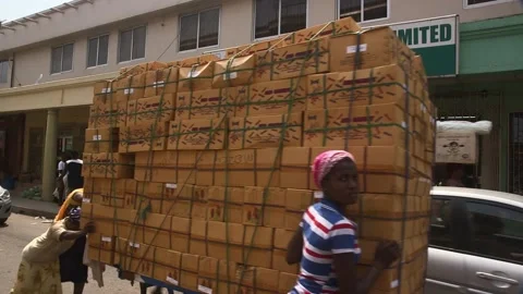Street workers transporting stacked cardboard boxes Stock Footage 341682324