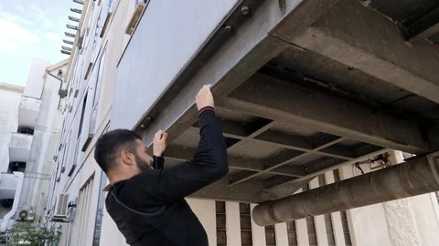 Street workout man doing pull ups exercise. Stock Footage 80925582