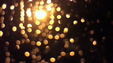 Streetlight raindrops on window macro bokeh Stock Footage 100606691