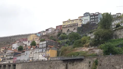 Streets cling to a steep hillside beside a river Stock Footage 344373876