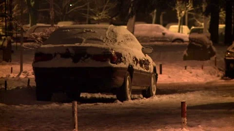 Streets covered with snow during the night, parked car Stock Footage 10734976