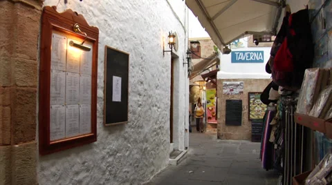 Streets of Lindos, old walls with stonework, tavern and narrow street. Greece. Stock Footage 32348985