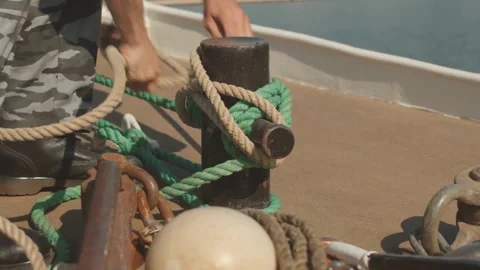 Strength and Precision A Sailor Secures the Boat with Skill Stock Footage 323779296