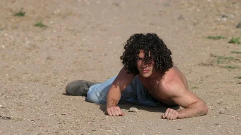 Strength, determination-man gets up from the ground and approaches the camera  Stock Footage 220506188