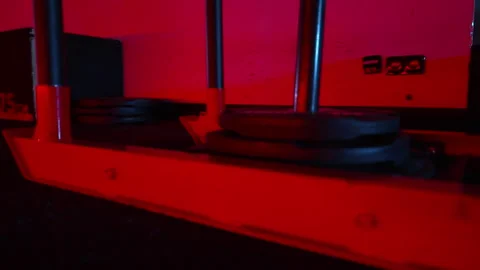 Strength Equipment Under Dramatic Red Light in Empty Gym Stock Footage 347248403