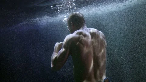Strength man is fighting alone underwater, muscular male back, subaquatic shot Stock-Footage 167377110