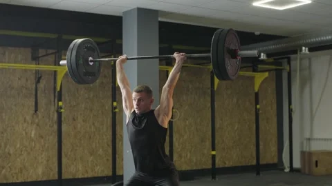Strength training session in gym with athlete lifting barbell Stock Footage 327078211