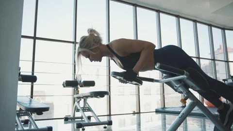 Strength training workout by a female trainer at a modern gym in the afternoon Video stock 313326854