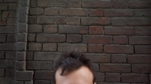Stress and problems. Portrait of a distressed young man, stands in an abandoned Stock Footage 77061355